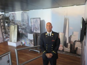 Retired NYFD Battalion Commander Jack Oehm in front of the fallen Towers and the risen Freedom Tower.
